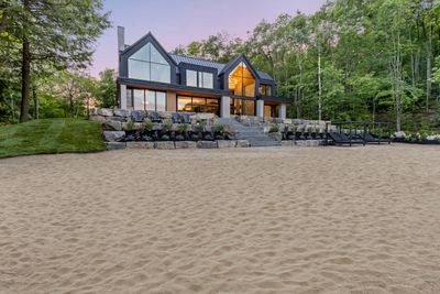 Contemporary Muskoka estate overlooking a private sand beach