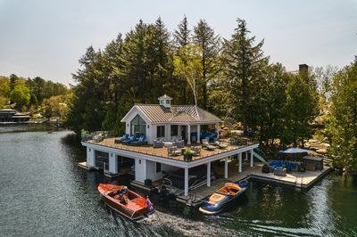Muskoka boathouse with boats ready at the dock