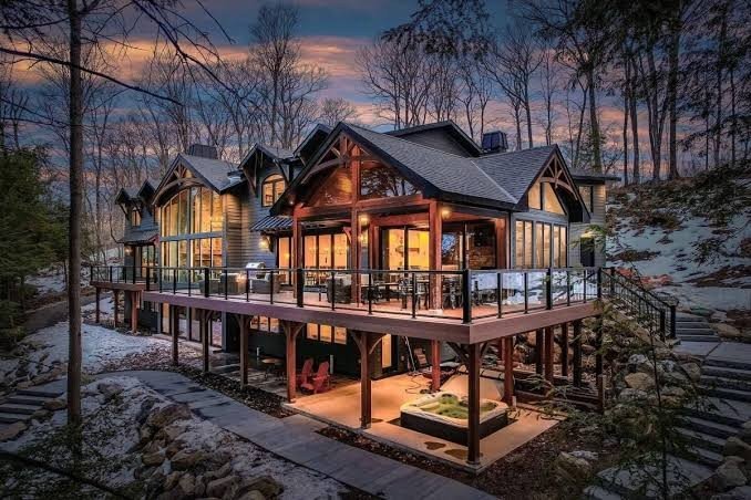 Snow covered Muskoka timber estate and deck at dusk in winter